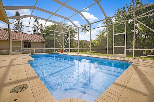 view of pool featuring a patio and glass enclosure