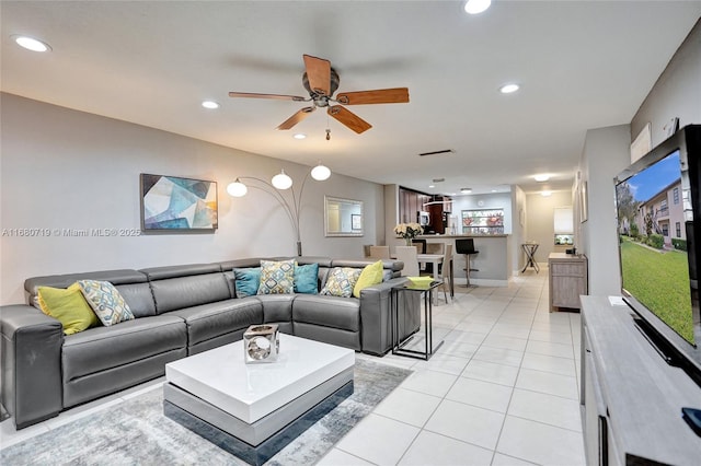 living room with light tile patterned floors and ceiling fan