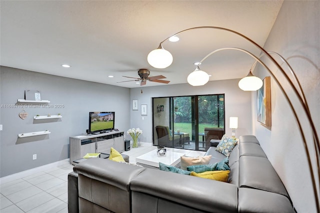 living room with ceiling fan and light tile patterned flooring