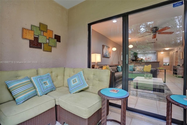 living room with ceiling fan and light tile patterned flooring