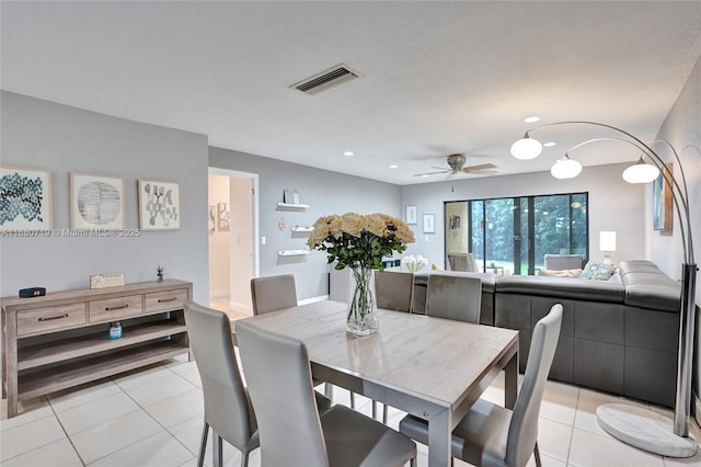 tiled dining room featuring ceiling fan