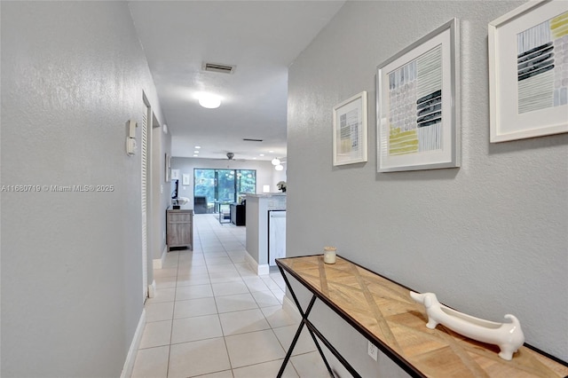 hall featuring light tile patterned floors