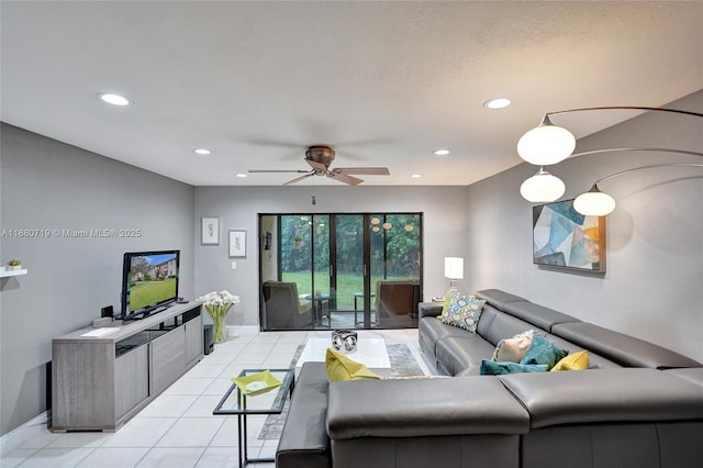 living room featuring ceiling fan and light tile patterned flooring