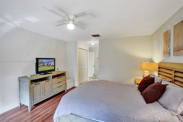 bedroom with ceiling fan, a closet, and light hardwood / wood-style floors