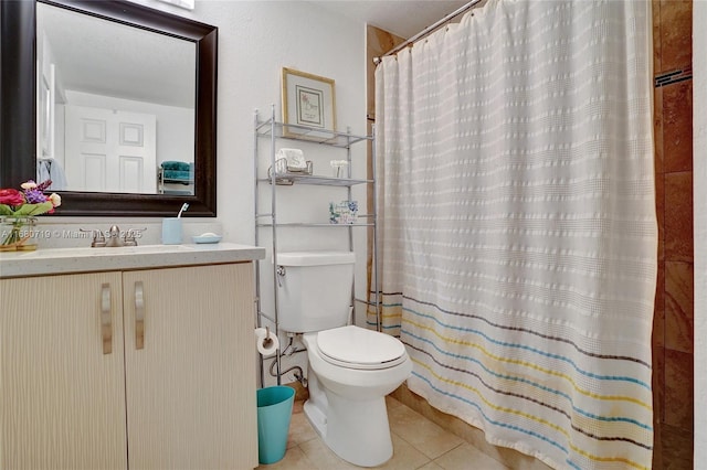 bathroom featuring toilet, tile patterned floors, curtained shower, and sink