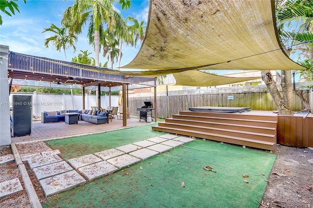 view of patio / terrace with area for grilling, an outdoor living space, and a jacuzzi