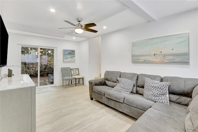 living room featuring beam ceiling, ceiling fan, and light wood-type flooring