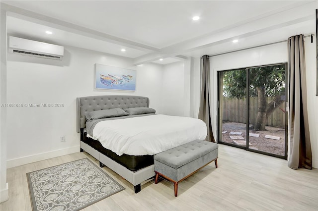 bedroom with beam ceiling, access to outside, a wall unit AC, and light wood-type flooring