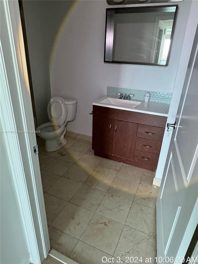 bathroom featuring vanity and toilet