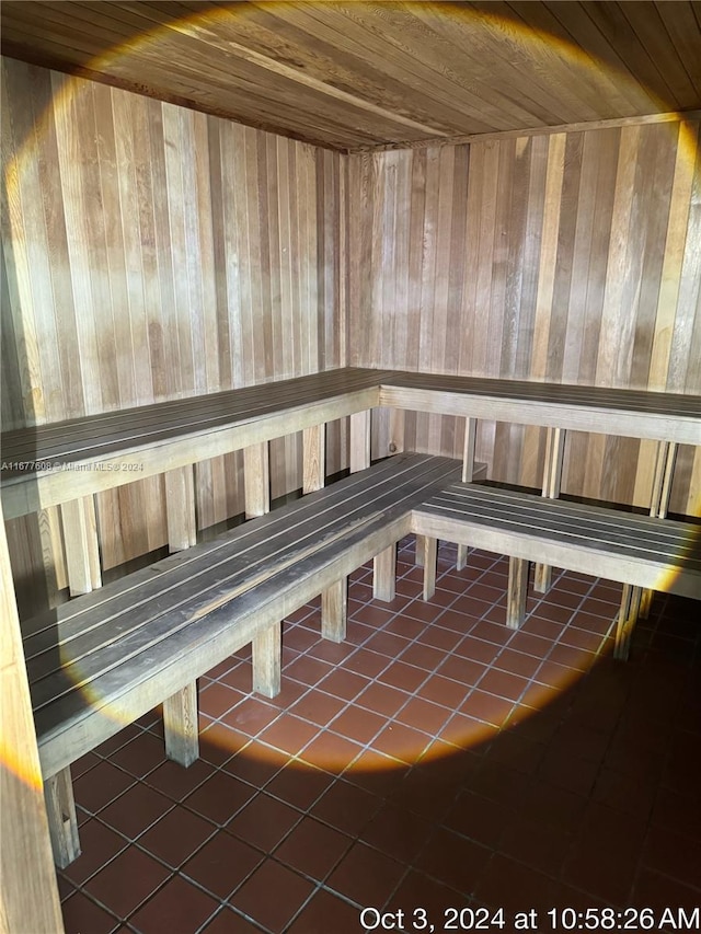 view of sauna / steam room featuring wooden walls, wooden ceiling, and tile patterned floors