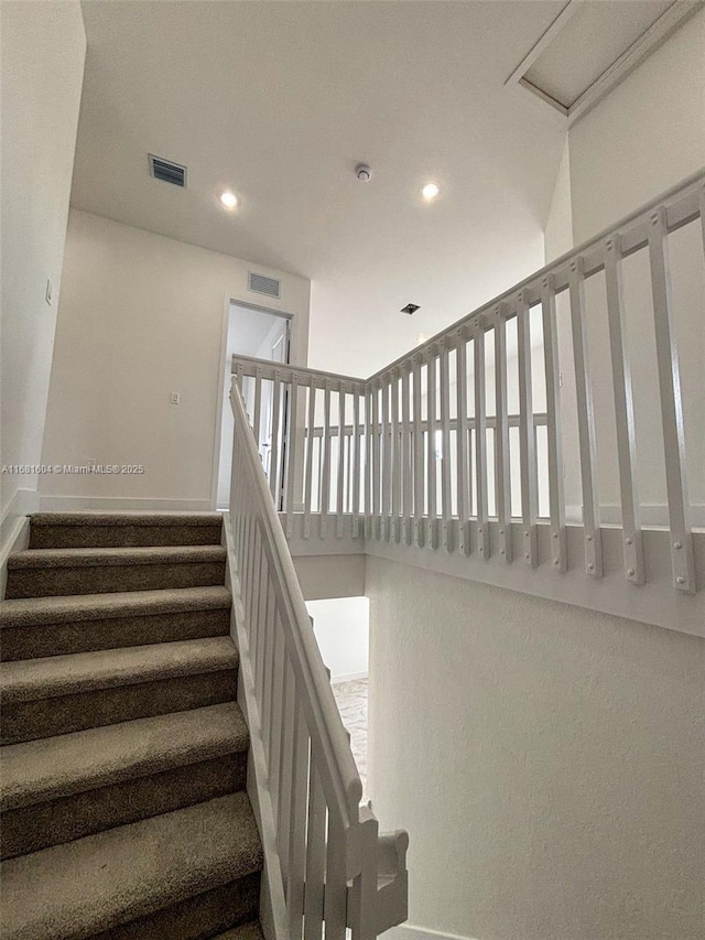 staircase featuring recessed lighting and visible vents