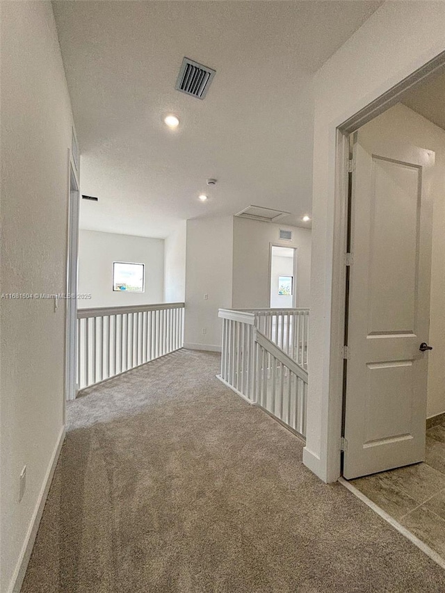 carpeted empty room featuring recessed lighting, visible vents, baseboards, and a textured ceiling