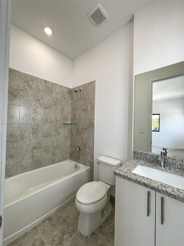 bathroom with vanity, tile patterned flooring, visible vents, toilet, and washtub / shower combination