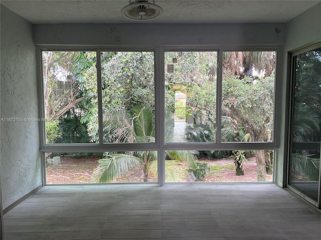 unfurnished sunroom with plenty of natural light