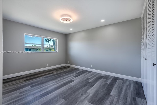 empty room featuring dark wood-type flooring