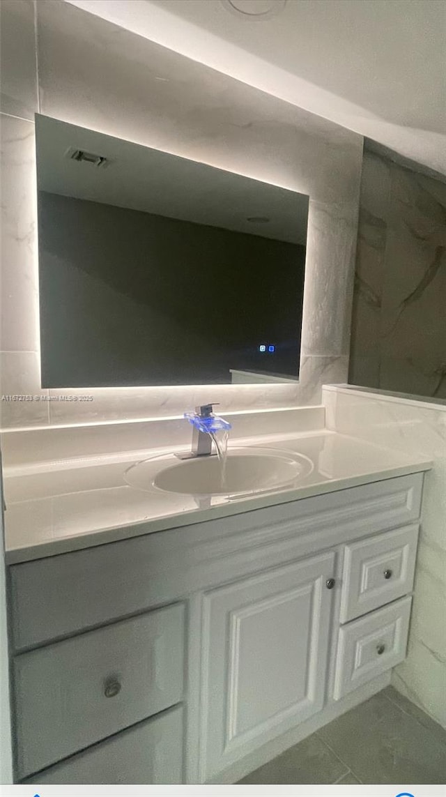 bathroom with vanity and tile patterned flooring