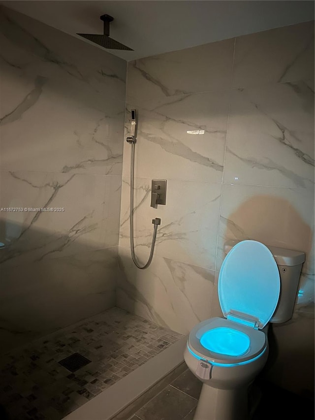 bathroom featuring tile patterned floors and tiled shower