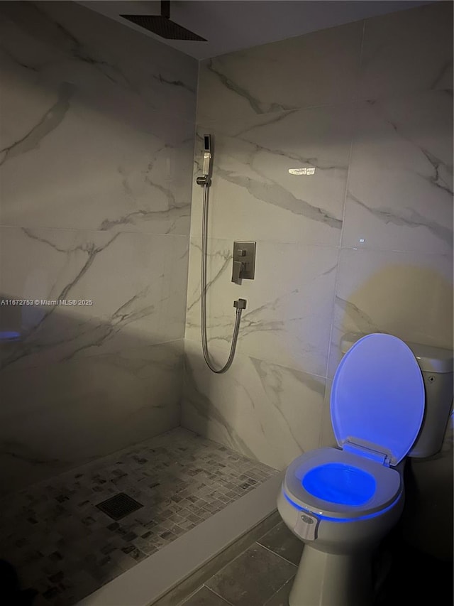 bathroom featuring tile patterned floors and tiled shower