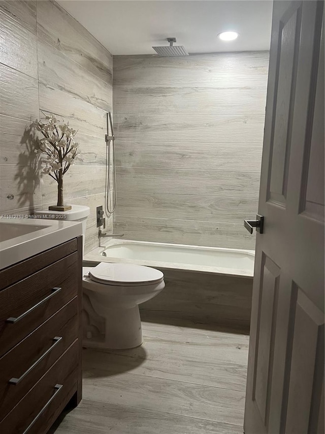 full bathroom featuring toilet, vanity, shower / washtub combination, and hardwood / wood-style floors