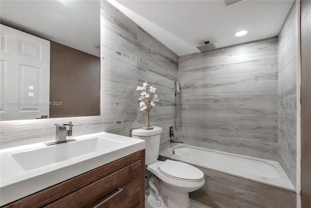 full bathroom with toilet, tiled shower / bath combo, and vanity