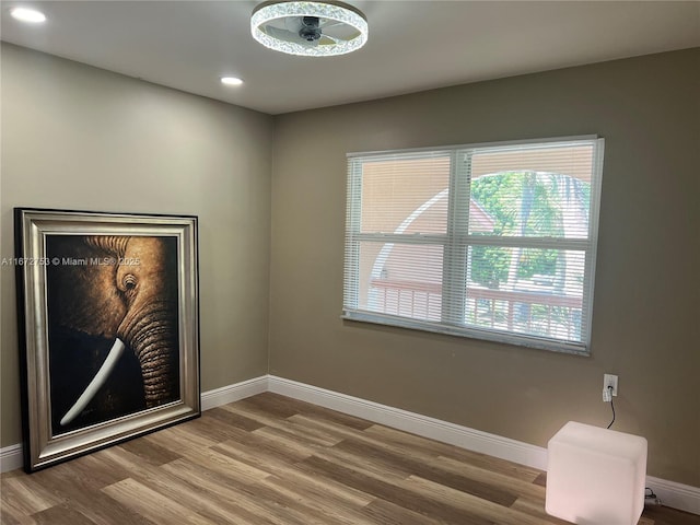 empty room with ceiling fan and wood-type flooring