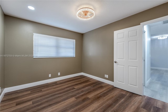 unfurnished bedroom with dark hardwood / wood-style floors