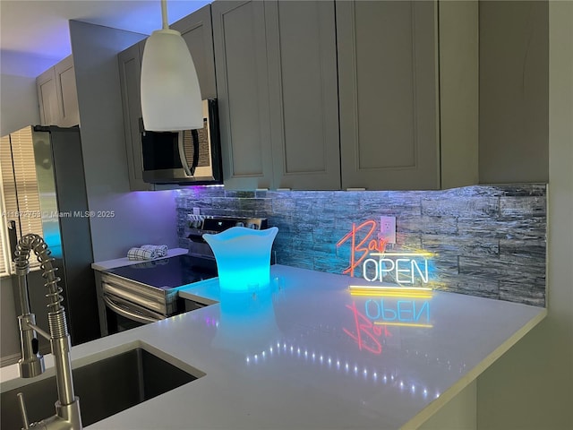 kitchen featuring electric range oven, gray cabinetry, sink, and tasteful backsplash