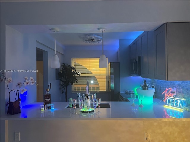 kitchen featuring decorative light fixtures and fridge