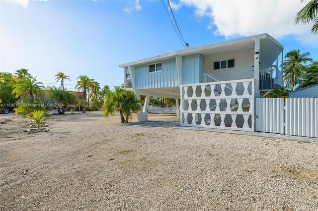 back of house featuring a carport