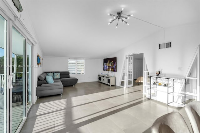 living room featuring lofted ceiling, a notable chandelier, and tile patterned floors