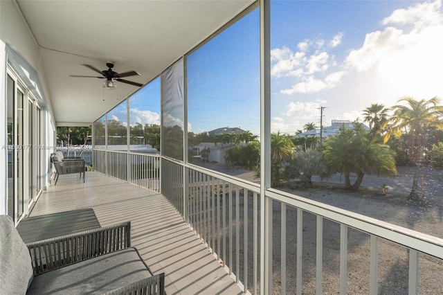 unfurnished sunroom with ceiling fan