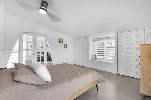 bedroom with french doors, two closets, and ceiling fan