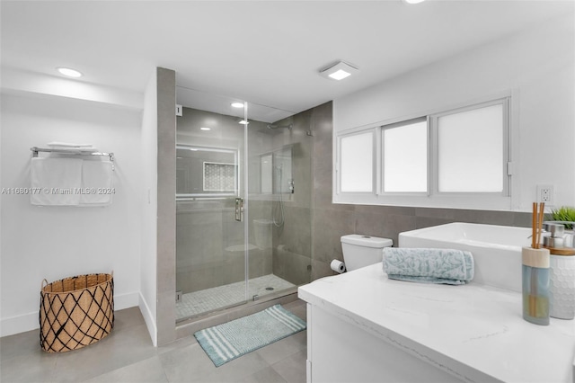 full bathroom with vanity, separate shower and tub, toilet, and tile patterned flooring