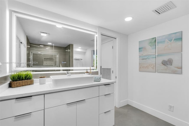 bathroom with vanity, a shower with shower door, and concrete floors