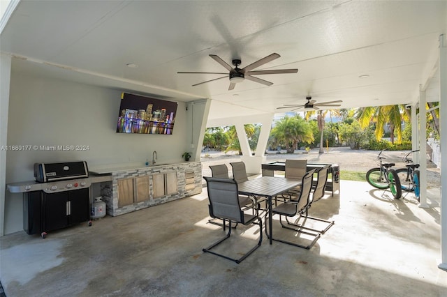 view of patio with ceiling fan, sink, and an outdoor kitchen