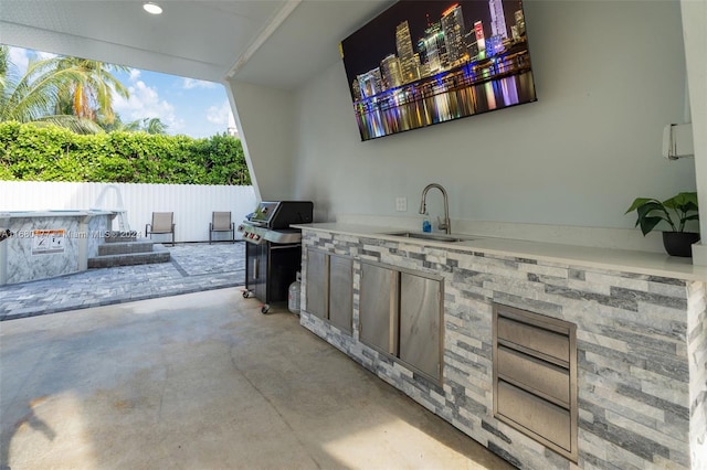 view of patio with area for grilling, sink, and an outdoor kitchen