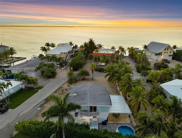 aerial view at dusk with a water view