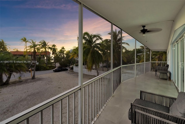 balcony at dusk with a patio area and ceiling fan