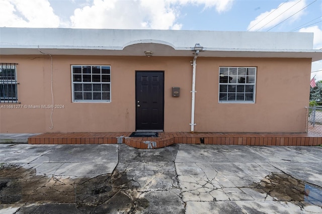 view of exterior entry featuring a patio area