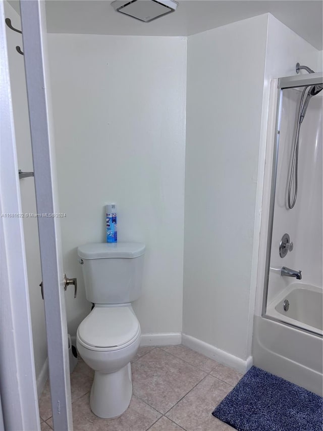 bathroom with tile patterned floors, toilet, and tub / shower combination