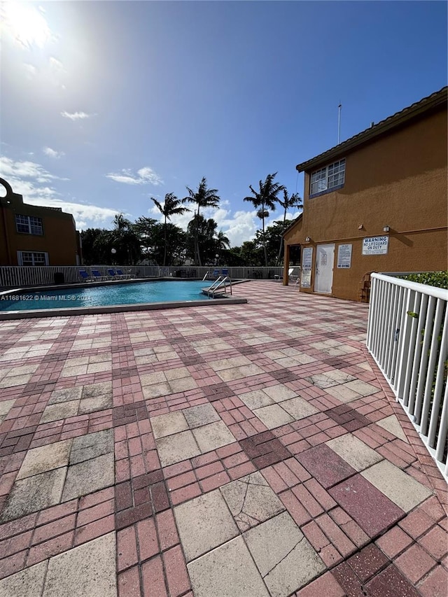 view of swimming pool featuring a patio area