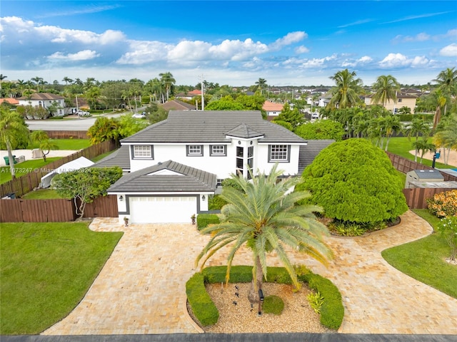 view of front of house featuring a front yard and a garage