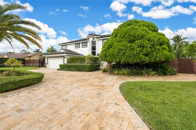 view of front facade with a front lawn and a garage