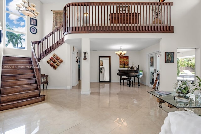 entryway with a towering ceiling and an inviting chandelier