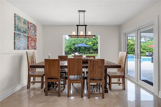 dining space with a notable chandelier