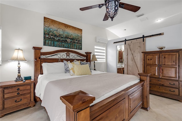 bedroom with a wall unit AC, lofted ceiling, ceiling fan, a barn door, and connected bathroom