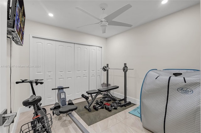 workout room with light tile patterned floors and ceiling fan