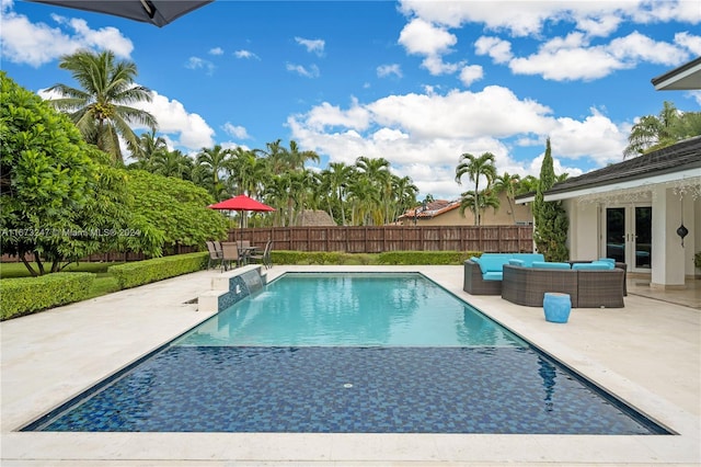 view of pool featuring a patio, pool water feature, and outdoor lounge area