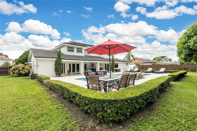 back of property featuring a patio, a yard, and an outdoor hangout area