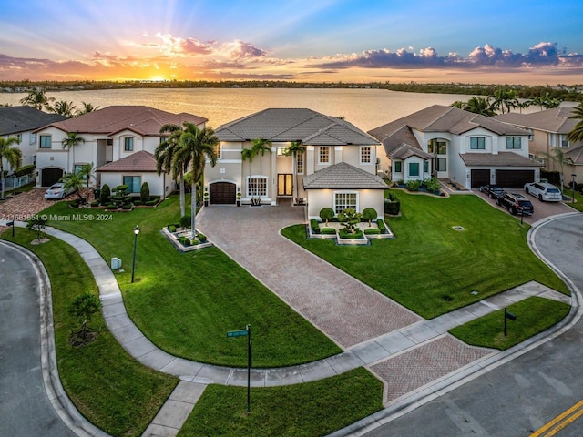 aerial view at dusk with a water view